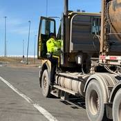 An RCMP officer at a truck's driver door