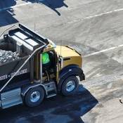 An RCMP officer at the passenger door of a dump truck