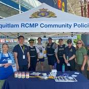 Group photo of Coquitlam RCMP Officers, staff, SHARE Society and Coquitlam Express hockey players