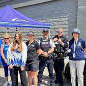 Group photo of Coquitlam RCMP Officers, staff, SHARE Society and Port Coquitlam/Ridge Meadows Ringette Association players