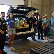 Group photo of Coquitlam RCMP officers and staff dropping off items to the SHARE Society