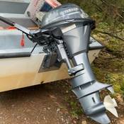 An image of the stolen Yamaha 15HP outboard boat motor on the rear of a small vessel
