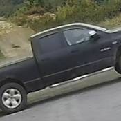 The stolen 4-door crew cab, black 2008 Dodge Ram pickup truck;