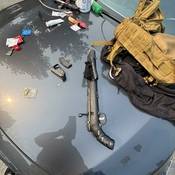 Picture of a loaded rifle among other items seized from the accused