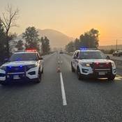 Two BC Highway Patrol cruisers blocking Highway #1 at the scene of a serious collision near Yale Road, Chilliwack