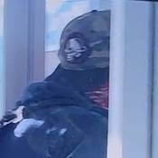 Suspect's hat, showing a black brim camouflage pattern with a white skull wearing a soldier helmet