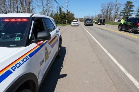 An RCMP vehicle sits at a roadside checkpoint