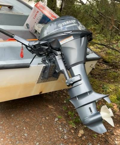 An image of the stolen Yamaha 15HP outboard boat motor on the rear of a small vessel