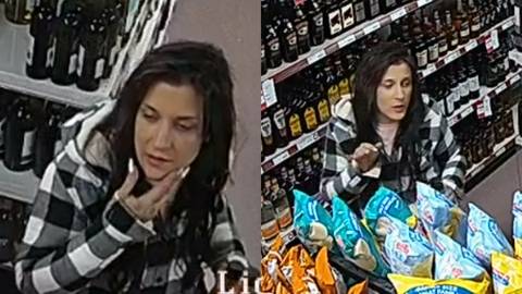 A woman is standing facing the security camera inside the store. She has long dark brown/black hair and painted nails.  She is seen wearing a hooded black and white plaid button up jacket and a light pink shirt.