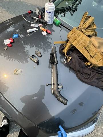 Picture of a loaded rifle among other items seized from the accused