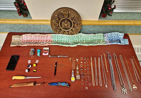 Seized items showing drugs, cash, weapons and recovered stolen property
