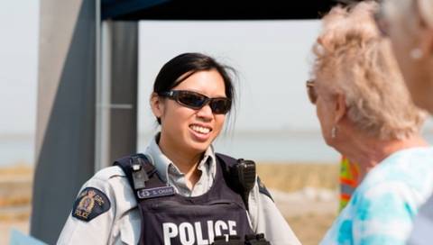 A female RCMP officer interacting with seniors