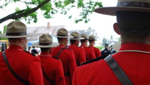 RCMP members lined up wearing serge